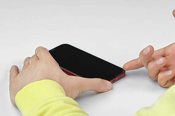 The protective glass is lifted from the fingernail.