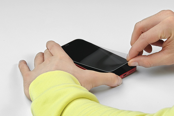 Slide your finger under the protective glass.