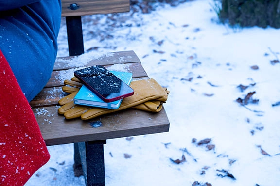 Mobile phone lies in the cold on a park bench