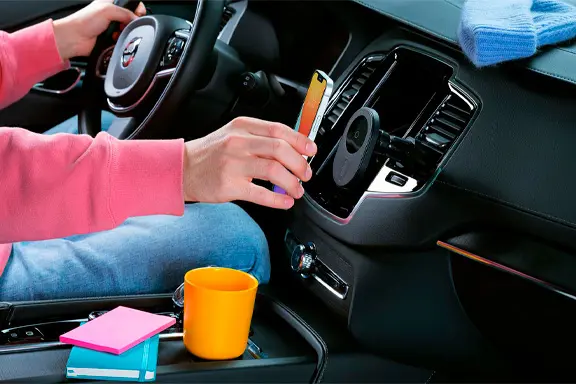 iPhone charges inductively in the car via a holder on the air vents.
