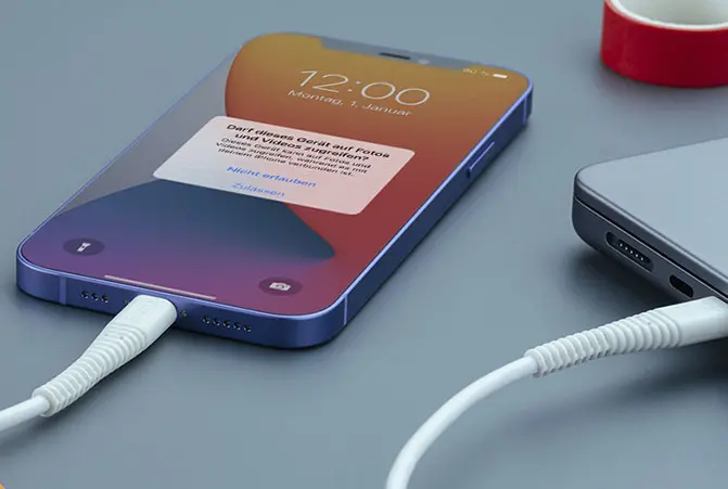 Mobile phone is connected to the notebook via a cable.