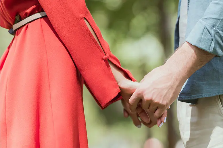 Holding hands is a popular selfie idea for couples.