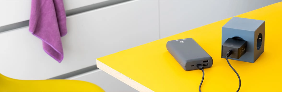 Power bank charges at a plug socket