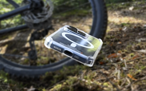 Smartphone in mobile phone case falls from the bike onto the forest floor.